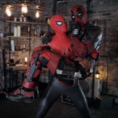 two deadpools are standing next to each other in a room with brick walls