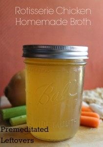 a mason jar filled with homemade broth sits on a table next to carrots and celery