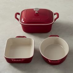 three red and white dishes sitting next to each other on top of a countertop