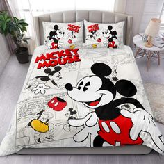 mickey mouse bedding set with red and white cartoon characters on it, in a bedroom