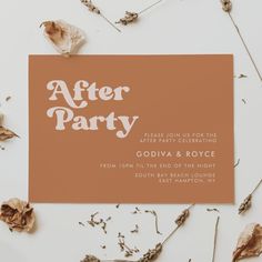 an orange and white after party card surrounded by dried leaves