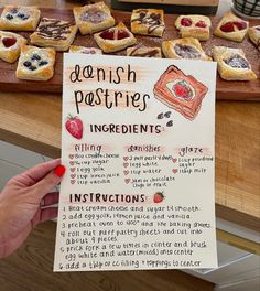 a person holding up a sign that says danish pastries ingredients and instructions on it