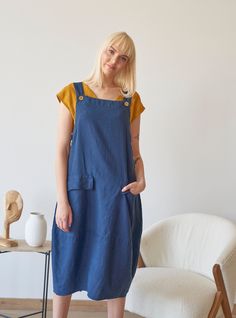 Made from prewashed and soft linen, this navy overall comes in dialogue with many different tops. Feel stylish in a natural way! Details: - 100% Linen - Pure linen fabric - Adjustable straps - Two front flap pockets - Side buttons closure - Below-knee length - Comfortable relaxed fit - Model's height is 178 cm / 5'10'' wears size M - Code: E9047-L532-152 The overall is available in other colors. You can find them in the gallery. If you want to order the overall in another color, please specify i Blue Cotton Pinafore Dress With Pockets, Sleeveless Linen Overalls, Sleeveless Linen Pinafore Dress With Pockets, Sleeveless Linen Overalls With Pockets, Blue Linen Dress With Pockets, Casual Dresses With Bib Front And Pockets, Casual Bib Front Dress With Pockets, Linen Overall, Womens Overalls