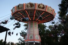 an amusement park ride with people riding on it