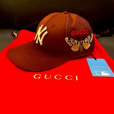 Good Condition Red/Burgundy Gucci Nyc Cap Comes With Dust Bag, Tags, Sticky Chip Gucci Brown Short Brim Hat, Designer Gucci Baseball Cap With Embroidered Logo, Brown Gucci Cap Hat, Gucci Casual Baseball Cap With Curved Brim, Luxury Gucci Baseball Cap, Casual Gucci Baseball Cap With Curved Brim, Gucci Brown Curved Brim Hat, Luxury Brown Hat With Embroidered Logo, Designer Brown Hat With Embroidered Logo