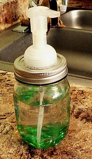 a hand soap dispenser sitting on top of a counter next to a sink