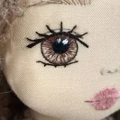 a close up of a stuffed animal with an eye