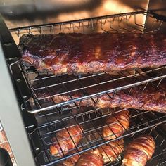 ribs and croissants cooking in an oven on top of the grill racks