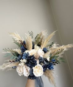 a vase filled with white and blue flowers