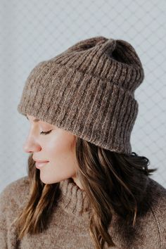 a woman wearing a brown hat and sweater