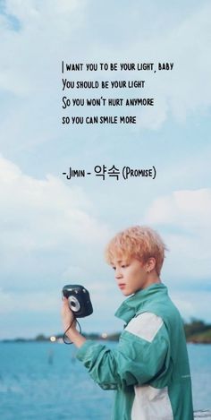 a boy holding a camera in front of the ocean with a quote above it that says, i want you to be your light baby