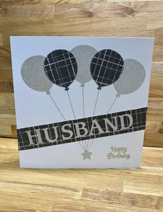 a greeting card with balloons and the words husband on it in black and silver foil