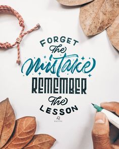 someone is writing on paper with leaves around it and the words forget the unstake, remember the lesson