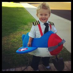 a little boy dressed up as a plane