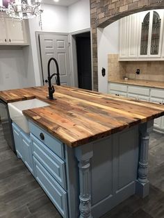 a kitchen island made out of wood and white cabinets