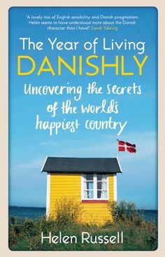 a yellow house with the words, the year of living danishly uncovered by helen russell