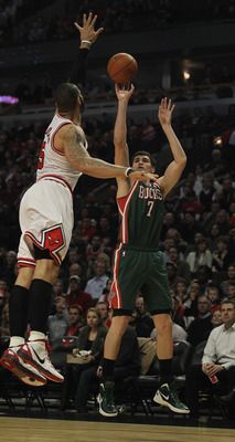 two men playing basketball in front of an audience