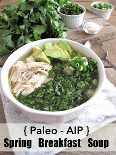 a white bowl filled with greens and meat