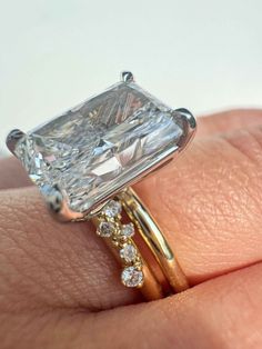 a close up of a person's hand with a ring on it and a diamond in the middle