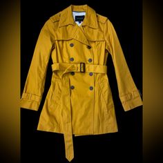 Light And Classic Trench Coat By Banana Republic Mustard Yellow Coat With Dark Brown Buttons Shell: 100% Cotton Lining: 100% Polyester Pit To Pit : Approx 17 Inches Length : Approx 30 Inches Lined Interior Removable Belt Double Breasted With Buttons Front Pockets Back Vent Cuffs With Belts In Excellent Condition. Never Worn But Tags Taken Off. Yellow Fall Outerwear For Work, Yellow Outerwear For Workwear In Fall, Yellow Winter Workwear Outerwear, Yellow Winter Outerwear For Work, Chic Mustard Outerwear For Fall, Classic Yellow Long Sleeve Outerwear, Chic Mustard Outerwear For Work, Trendy Mustard Outerwear For Spring, Trendy Yellow Outerwear For Work