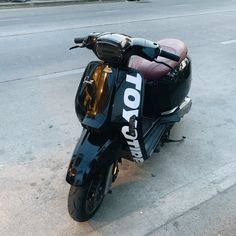 a motor scooter parked on the side of the road