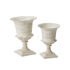 two white vases sitting on top of each other