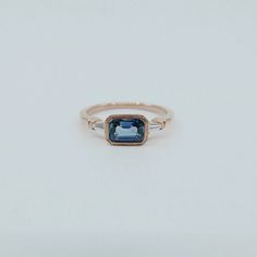 a blue and white diamond ring on a white background