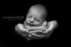 a black and white photo of a baby sleeping in his hands with the caption lovel moments