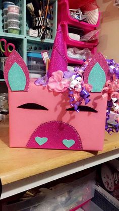 a pink box with a unicorn's face on it sitting on top of a table