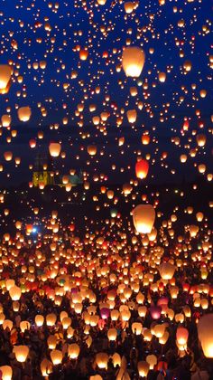 many lanterns are floating in the air at night, and there is no image to describe