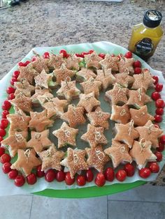 a platter filled with star shaped cookies on top of a table