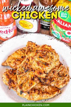 grilled chicken on a white plate with sauces and seasonings in the background