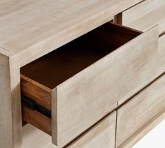 a close up of a wooden dresser with drawers