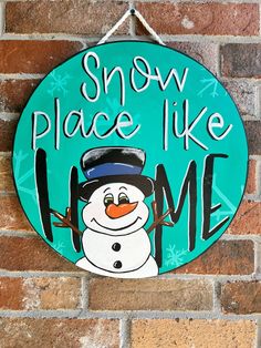 a sign that says snow place like me with a snowman on the front and back