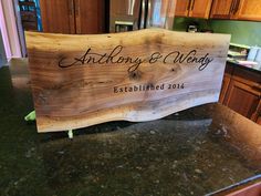 a wooden sign sitting on top of a kitchen counter