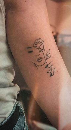 a woman with a rose tattoo on her arm