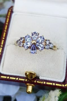 a ring with three stones in it sitting on top of a box