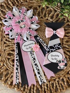 some pink and black hair clips are on a wicker basket next to a potted plant