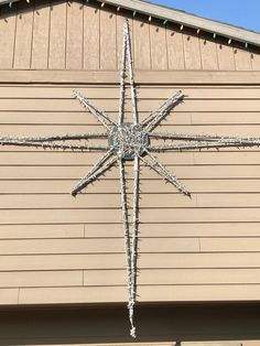 a large metal star on the side of a building