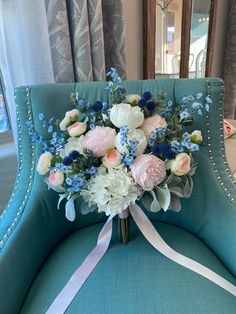 a bouquet of flowers sitting on top of a blue chair