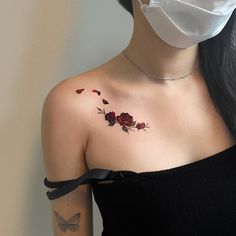 a woman wearing a face mask with roses on her chest