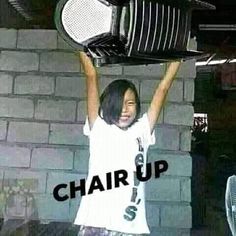 a woman holding up a microwave over her head with the words chair up above her head