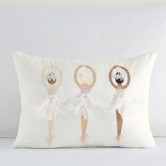 three little ballerinas on a white pillow