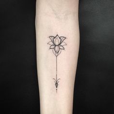 a black and white photo of a flower tattoo on the left arm with an arrow