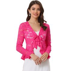 Opt for a decadent cover-up for your special occasions with this lace shrug. This stretchy lace cardigan offers the perfect balance to longer layers in a waist-defining cut with a tie front. Constructed in a classic shrug silhouette, this charming piece benefits from an open neck and elegant long sleeves with ruffles. Intricate design details include a satin binding around the front and hem and a floral lace design. Paired with a sleeveless dress, spaghetti strap, tank top, or simple off-shoulde Party Lace Shrug With Lace Sleeves, Spring Party Lace Shrug, Spring Party Shrug With Lace Trim, Party Shrug With Lace Trim, Spring Lace Shrug With Lace Sleeves, Fitted Lace Cardigan With Crochet Lace, Fitted Lace Cardigan With Crochet Details, Long Sleeve Lace Shrug With Lace Trim, Fitted Lace Cardigan For Party