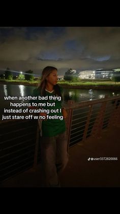 a woman standing next to a river at night with a quote written on the side