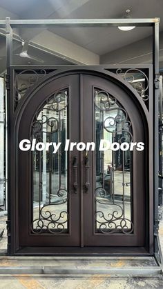 an iron door with glass panels on the front and side doors are shown in black