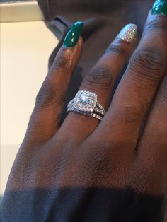 a close up of a person's hand with two rings on their fingers and one ring in the middle