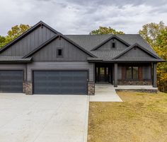 a large gray house with two garages