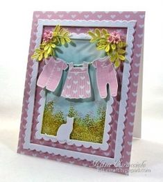 a card with an image of a baby's dress and flowers on the front